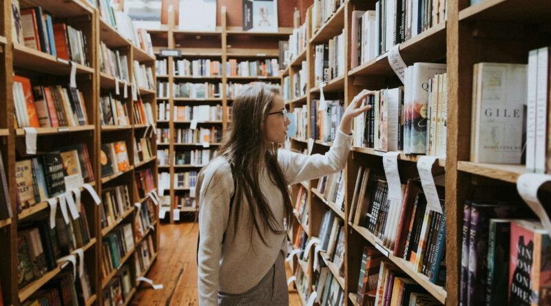 college student looking for books in college library